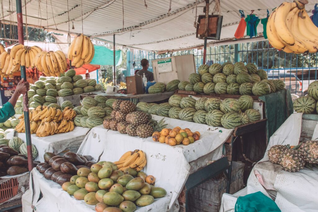 pin pics a typical fresh fruits stand in kenya with fresh tropical fruits arranged nicely.