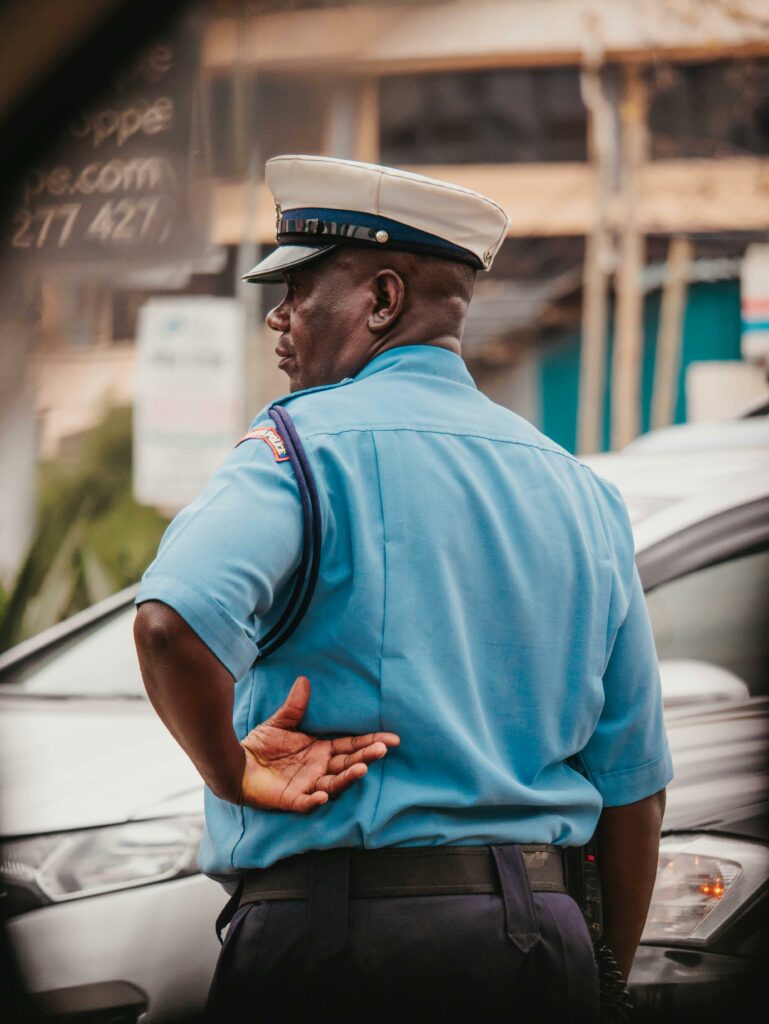 pexels-photo-27928792-27928792 Traffic police officer in uniform managing vehicles on a busy Nairobi street.