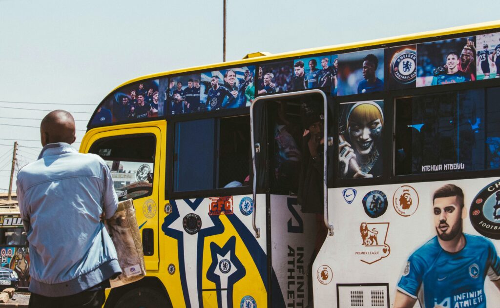 pexels-photo-30661414-30661414 A vibrant matatu bus adorned with football artwork in Nairobi, Kenya, showcasing local culture and sports enthusiasm.